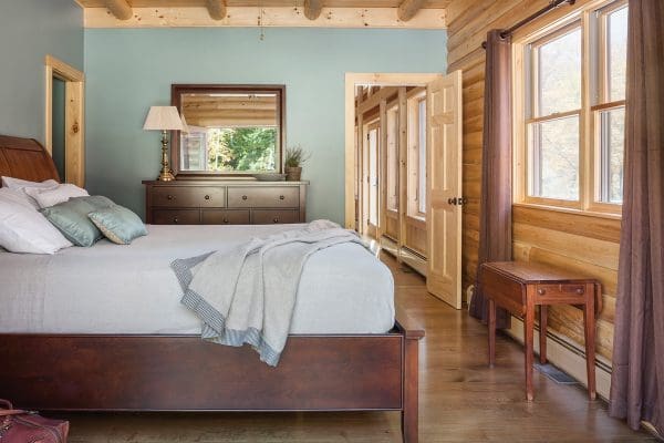 Master bedroom with interior painted blue walls and wooden ceiling