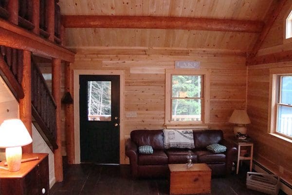 The living room in a cozy log cabin from Big Twig Homes.